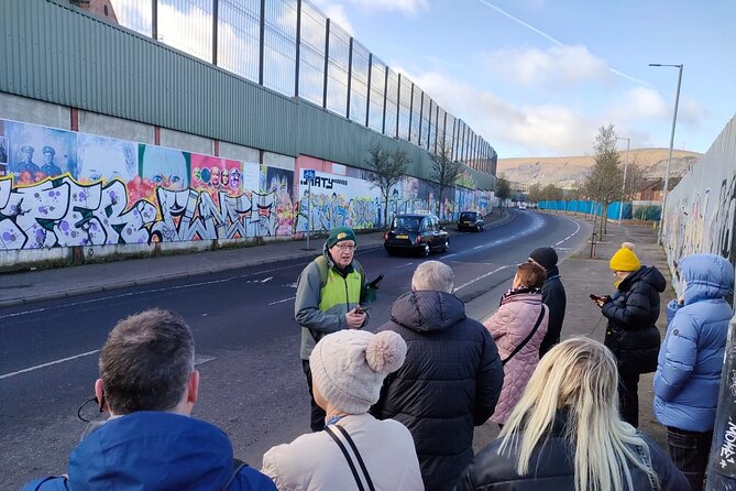 Belfast Troubles Tour: Walls and Bridges - Murals on Divis Street explain the public argument