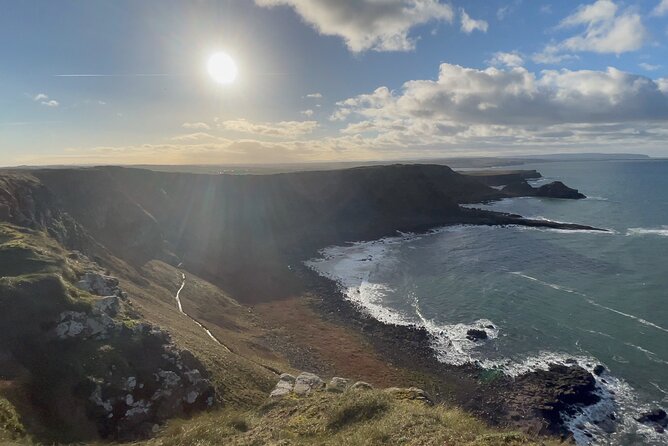 Giants Causeway Tour from Belfast + FREE Belfast Mural Tour - Dunluce Castle, a dramatic ruin above the sea